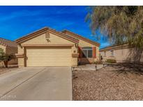 Charming single-story home showcasing a well-maintained front yard and attached two-car garage at 2172 W Pinkley Ave, Coolidge, AZ 85128