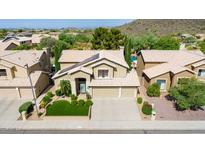 Aerial view of two-story house with solar panels, landscaped yard, and three-car garage at 23046 N 21St St, Phoenix, AZ 85024