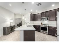 Modern kitchen with stainless steel appliances and white quartz countertops at 2511 W Queen Creek Rd # 415, Chandler, AZ 85248