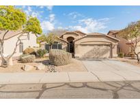 One-story house with beige exterior, two-car garage, and landscaped front yard at 2805 N 111Th Dr, Avondale, AZ 85392