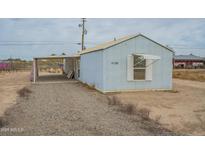 Ranch style home with carport and gravel driveway at 3100 W Quail Rd, Eloy, AZ 85131