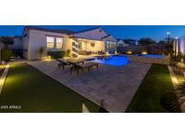 Stunning backyard with a pool, spa, putting green, and patio at 4552 S Flare --, Mesa, AZ 85212