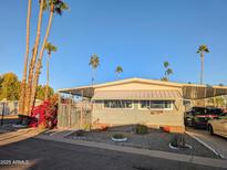 Single-wide manufactured home with carport and landscaped yard at 7300 N 51St Ave # F91, Glendale, AZ 85301