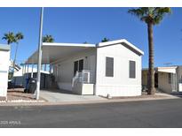 Charming single-story home with covered parking and manicured landscaping at 7807 E Main St # F36, Mesa, AZ 85207