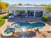 Inviting backyard oasis featuring a large pool, spa, and outdoor entertainment area at 922 E Desert Hills Estate Dr, Phoenix, AZ 85086