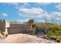 Stunning desert landscape surrounds this contemporary home with a large, inviting driveway at 10040 E Happy Valley Rd # 1041, Scottsdale, AZ 85255