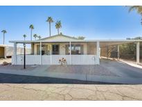 Inviting manufactured home with covered carport and landscaped yard at 120 N Val Vista Dr # 186, Mesa, AZ 85213