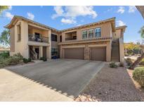 Two-story stucco home with attached garage and balcony at 21320 N 56Th St # 2144, Phoenix, AZ 85054