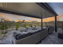 Covered patio with seating area, desert landscaping, and mountain views at 2156 W Sierra Sunset Trl, Phoenix, AZ 85085