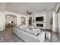 Bright, open living room with fireplace and a large comfortable couch at 4747 S Aileron Ln, Mesa, AZ 85212