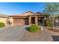 Single-story home with a two-car garage and well-manicured landscaping at 5001 S 236Th Dr, Buckeye, AZ 85326