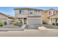 Two-story house with gray exterior, two-car garage, and landscaping at 7143 W Golden Ln, Peoria, AZ 85345