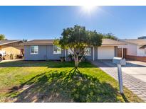 House with gray exterior, lawn, and mailbox; curb appeal at 7749 W Orange Dr, Glendale, AZ 85303