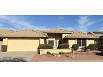 Charming single-story home with a well-manicured front yard and a two-car garage in a sunny neighborhood at 8450 W Rose Pilar Ct, Peoria, AZ 85382