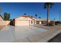 Single-story home with a two-car garage and desert landscaping at 9818 W Mohawk Ln, Peoria, AZ 85382