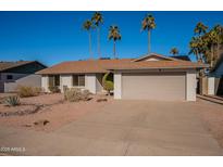 Single-story home with a two-car garage and desert landscaping at 1348 E Chilton Dr, Tempe, AZ 85283