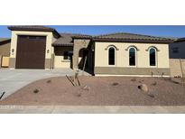 New construction home with a two-car garage and desert landscaping at 17330 W Royal Palm Rd, Waddell, AZ 85355