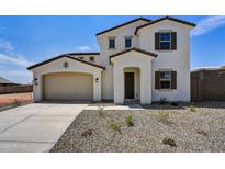 Two-story house with tan exterior, and a two-car garage at 19339 W Valle Vista Way, Litchfield Park, AZ 85340