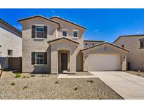 Two-story house with light beige exterior, two-car garage, and desert landscaping at 19436 W Valle Vista Way, Litchfield Park, AZ 85340