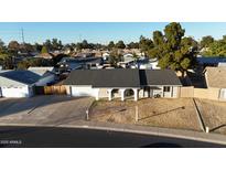 Single-story home with a two-car garage and a spacious yard at 2618 W Surrey Ave, Phoenix, AZ 85029