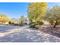 Single-story home with paved driveway, landscaping, and a covered entryway at 28821 N Ashbrook Ln, Queen Creek, AZ 85144