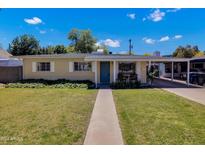 Charming single-story home with a well-manicured lawn and walkway at 303 W 9Th St, Mesa, AZ 85201