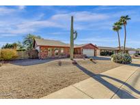 Brick ranch home with desert landscaping and a two-car garage at 3101 W Topeka Dr, Phoenix, AZ 85027