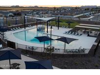 Community pool with a splash pad, lounging areas, and grills at 3201 E Hayden Rose Ave, San Tan Valley, AZ 85143