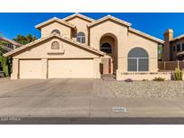 Two-story house with three-car garage and landscaped yard at 4968 E Grandview Rd, Scottsdale, AZ 85254