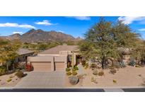 Single-story home with a two-car garage and desert landscaping at 6358 E Evening Glow Dr, Scottsdale, AZ 85266