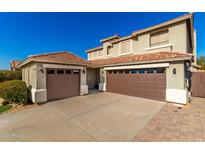 Two-story house with two-car garage and desert landscaping at 6414 W Villa Linda Dr, Glendale, AZ 85310