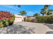 Front view of a single-story home with attached garage and landscaped yard at 7258 E Manzanita Dr, Scottsdale, AZ 85258