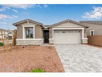 Charming single-story home with a two-car garage and desert landscaping at 8333 N 54Th Ln, Glendale, AZ 85302