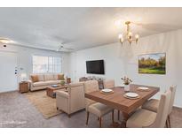 Inviting living room and dining area with a neutral color palette and modern furnishings at 10863 W Thunderbird Blvd, Sun City, AZ 85351