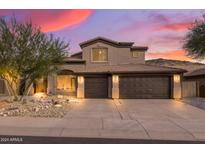 Two-story house with a three-car garage and desert landscaping at 14035 E Sahuaro Dr, Scottsdale, AZ 85259