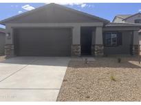 Charming single story home with a two car garage and low maintenance desert landscaping at 20622 N 226Th Ln, Surprise, AZ 85387