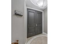 Sophisticated entry with double doors and modern light fixture at 2211 E Camelback Rd # 1202, Phoenix, AZ 85016