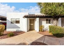 White stucco exterior, private entrance, and well-maintained landscaping at 2400 N 71St St # T, Scottsdale, AZ 85257