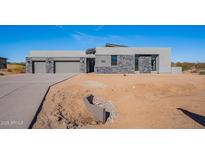 Modern home with stone accents and three-car garage at 25580 N 119Th St, Scottsdale, AZ 85255
