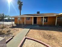 House exterior featuring a walkway to the front door and a palm tree at 5019 W Roma Ave, Phoenix, AZ 85031