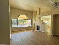Bright living room featuring a fireplace and large window at 5937 E Jensen St, Mesa, AZ 85205