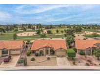 Inviting single-story home with terra cotta roof and desert landscaping, backing onto a golf course at 9447 W Tonto Ln, Peoria, AZ 85382