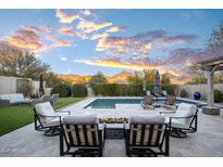 Stunning backyard with a sparkling pool, fire pit, and mountain views at 18391 N 97Th Pl, Scottsdale, AZ 85255