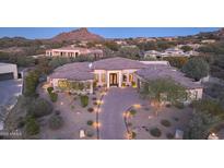 Stunning desert home with a tile roof, stone accents, and a landscaped yard at 26475 N 106Th Way, Scottsdale, AZ 85255