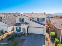 Two-story house with tile roof, driveway and landscaping at 5323 W Chuck Box Rd, Laveen, AZ 85339