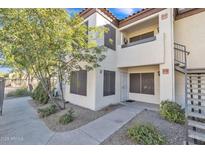 Attractive exterior of a two-story condo building with landscaping and walkway at 9990 N Scottsdale Rd # 1036, Paradise Valley, AZ 85253