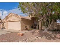 Charming single-story home featuring a desert-landscaped front yard and attached two-car garage at 11606 W Laurelwood W Ln, Avondale, AZ 85392