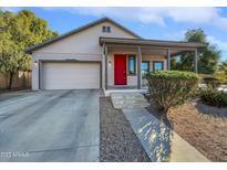 Single-story home with red door, attached garage, and landscaped front yard at 1451 W Homestead Ct, Chandler, AZ 85286