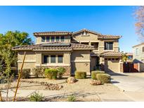 Two-story house with desert landscaping, a three-car garage, and solar panels at 21932 S 185Th Way, Queen Creek, AZ 85142
