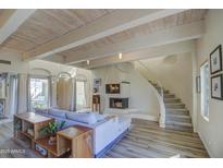 Light-filled living room with a fireplace and spiral staircase at 6411 S River Dr # 11, Tempe, AZ 85283